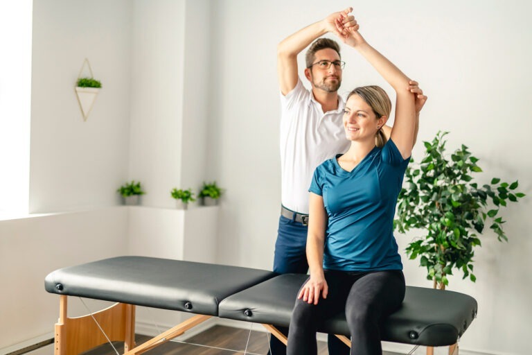 A Modern rehabilitation physiotherapy man at work with woman client